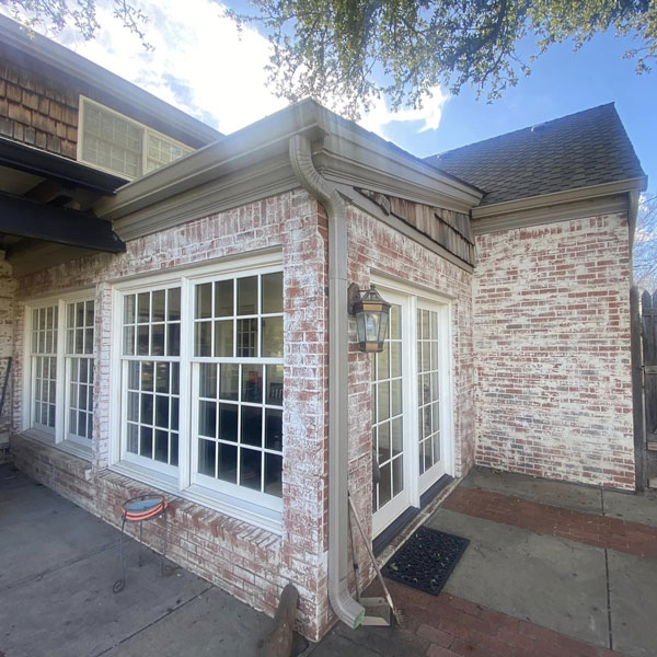 house exterior with new windows and gutters